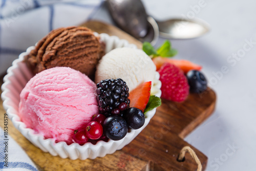 Selection of colorful ice cream scoops in white bowls