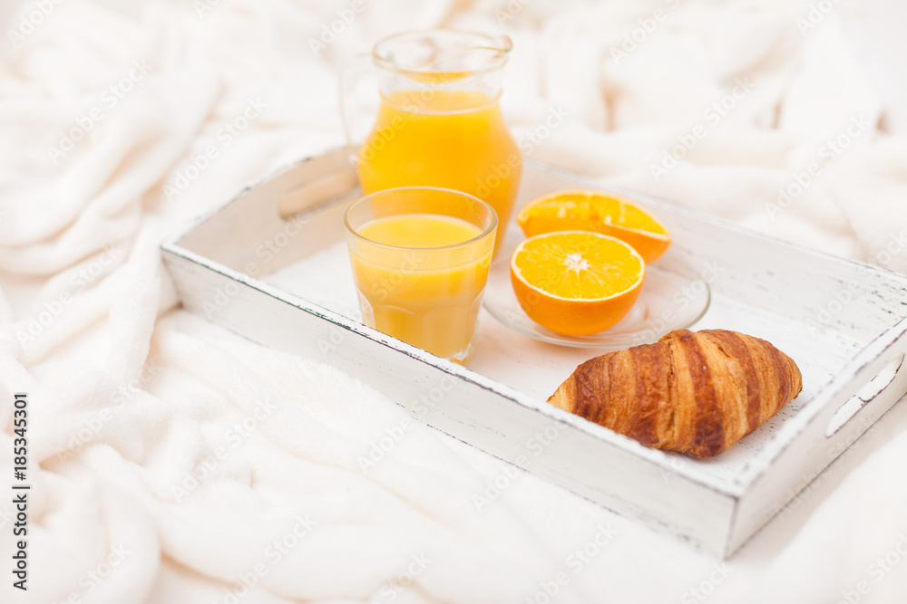 Freshly baked croissant, orange juice, jam, cup of black coffee on white wooden tray on plaid. Homemade cookie. Fresh pastries for breakfast. Delicious dessert. Closeup photography. Horizontal banner Freshly baked croissant, orange juice, jam, cup of black coffee on white wooden tray on plaid. Homemade cookie. Fresh pastries for breakfast. Delicious dessert. Closeup photography. Horizontal banner