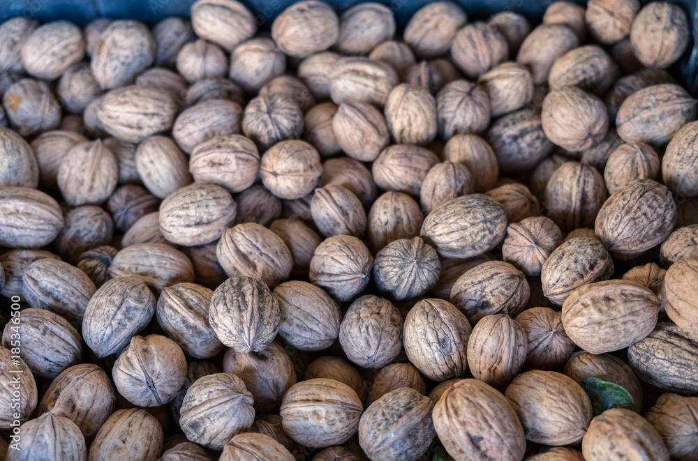 Unpeeled english walnuts for sale at Porto market (Mercado do Bolhao). Portugal. Top view Unpeeled english walnuts for sale at Porto market (Mercado do Bolhao). Portugal. Top view