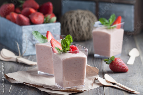 Strawberry and raspberry yugurt in buffet jar with banana, milk and creem cheese photo