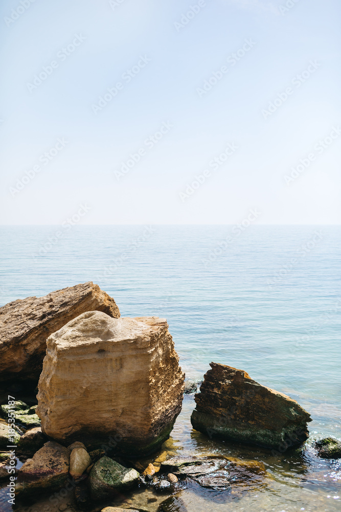 Large rocks stand in the sea waters