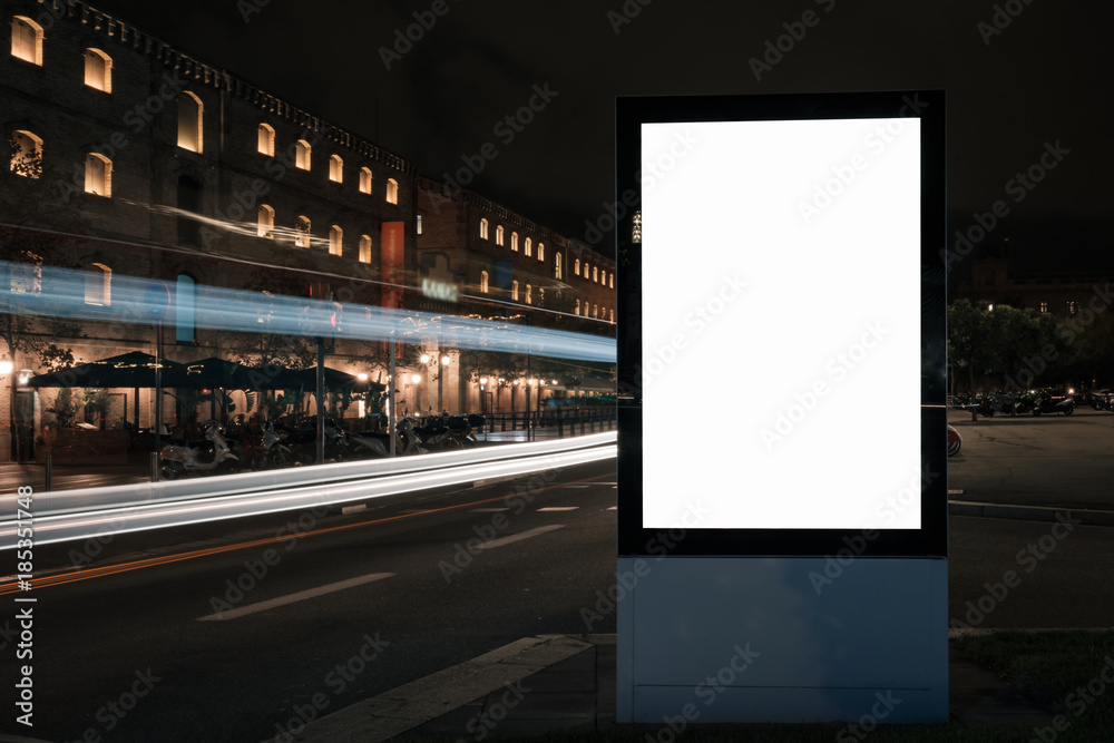Blank white advertisement lightbox in at night. Mock-up design. Colourful car light lines. Blank white advertisement lightbox in at night. Mock-up design. Colourful car light lines.