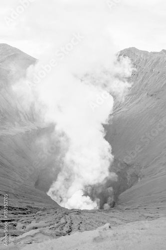 Close-up volcano crater erupting black and white