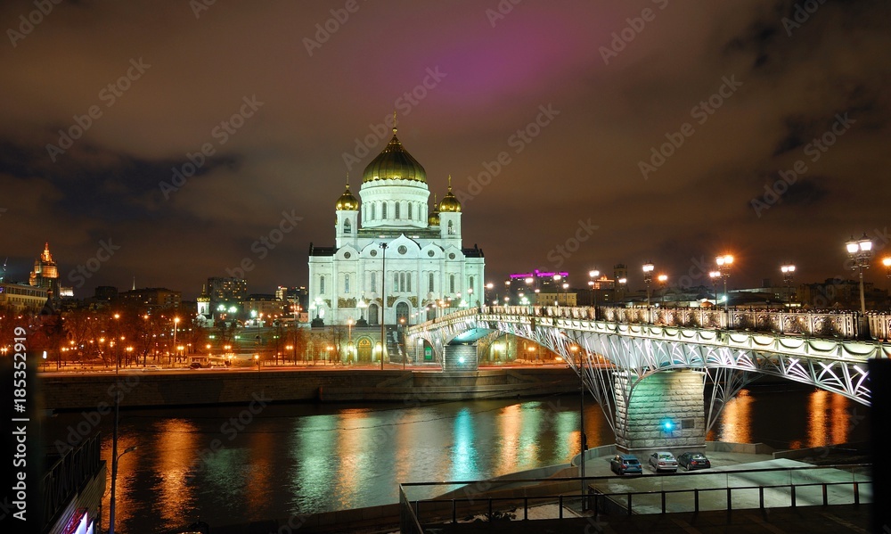 View of Temple of Christ Savior at night. Moscow, Russia/He stands on banks of  Moscow river, it leads to bridge. Taken late evening, before Christmas, festive illumination of city 