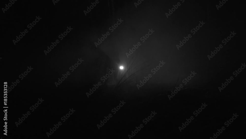 Silhouette of a man running through the forest at winter night Silhouette of a man running through the forest at winter night