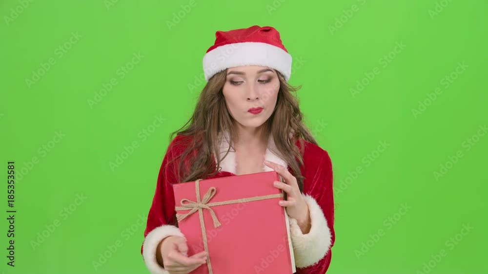 Girl in a snow maiden costume holds a gift . Green screen. Close up Girl in a snow maiden costume holds a gift . Green screen. Close up