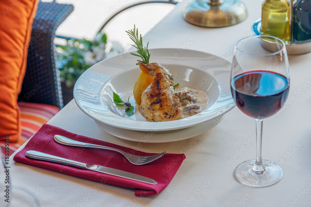 Summer lunch with red wine and a roasted duck leg Summer lunch with red wine and a roasted duck leg
