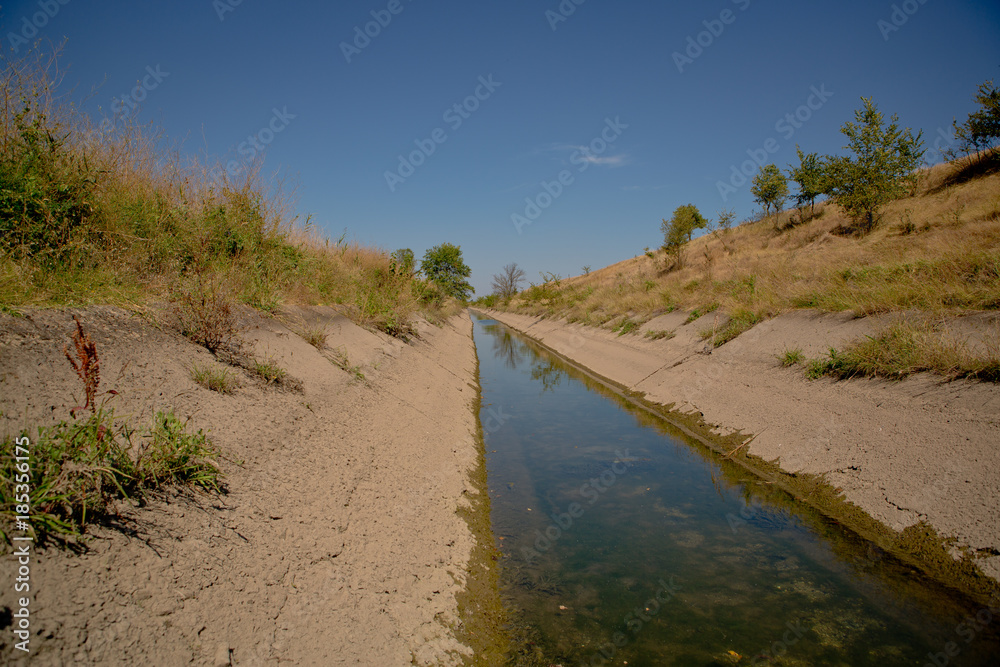 irrigation canal. Old irrigation canal made of concrete slabs irrigation canal. Old irrigation canal made of concrete slabs