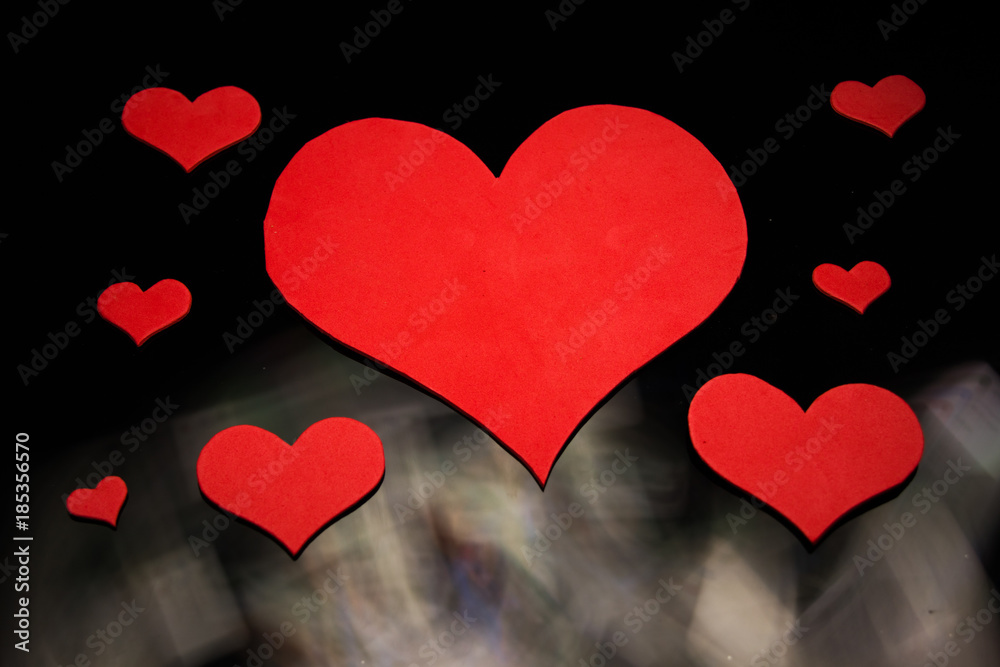 Red hearts on a black background