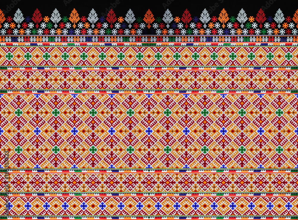 CLOSE UP THE SEAMLESS PATTERN OF COLORFUL CLOTHES. THE HANDMADE EMBROIDERY DID BY HILL TRIBE WOMEN.