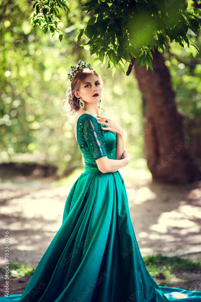 Young woman wearing a green dress explores a magical forest Young woman wearing a green dress explores a magical forest