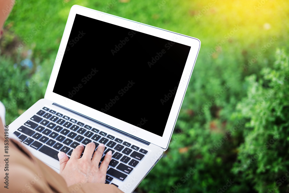 business woman hand using laptop on table in garden. business woman hand using laptop on table in garden.