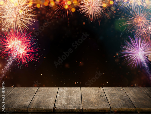 Abstract colored firework background with empty wooden planks, free space for product placement.
