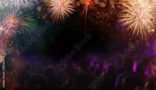 Abstract colored firework background with people silhouettes  free space for text.