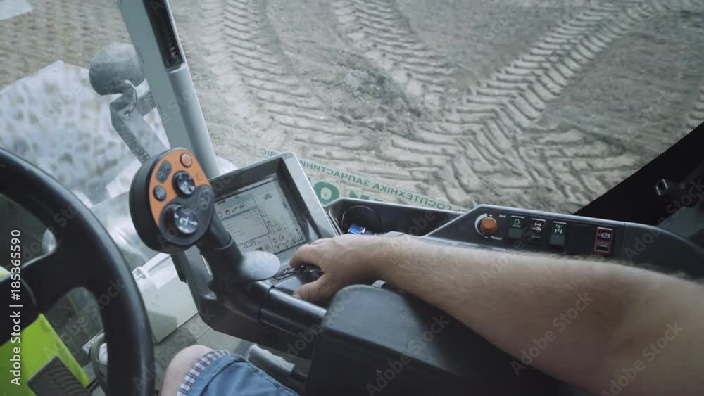 Tractor driver point of view. View from inside cabin driver farming tractor using touch screen monitor modern tractor. Tractor cabin control system