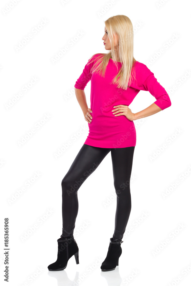 Serious And Confident Fashion Model Is Standing And Looking Away Serious And Confident Fashion Model Is Standing And Looking Away