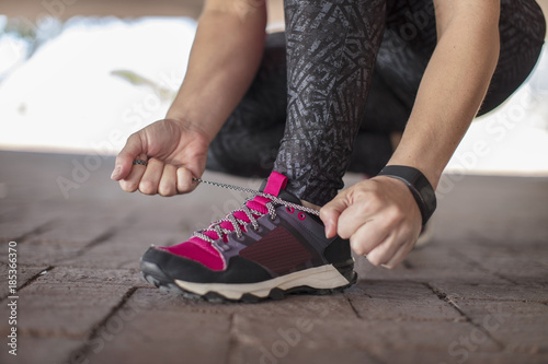 Sportive woman tying her shoes