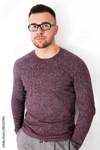 Handsome serious man in glasses isolated on a white background © ribalka yuli
