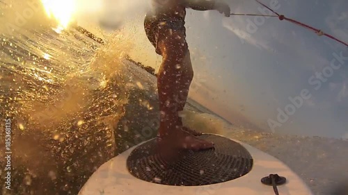 Slow motion of sportive man surfing on wakeboard