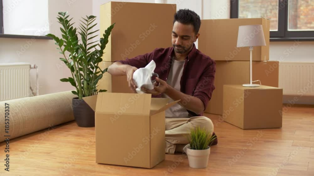 man packing boxes and moving to new home