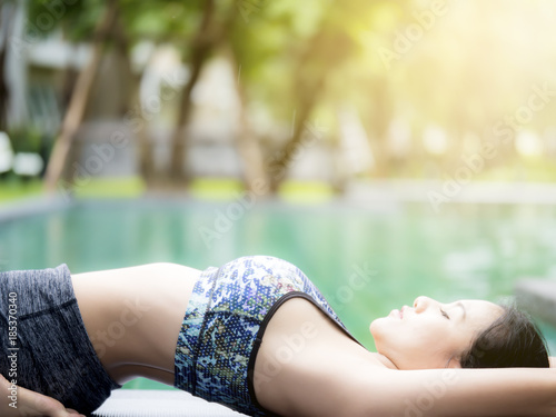 Young woman is practicing yoga and pilates on nature. Morning meditation at summer