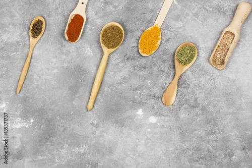 Various spices on a gray background. Top view, copy space. Food background