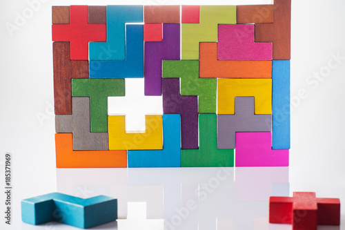 Abstract Background. Background with different colorful shapes wooden blocks. Geometric shapes in different colors. Concept of creative, logical thinking or problem solving. Decision making process.