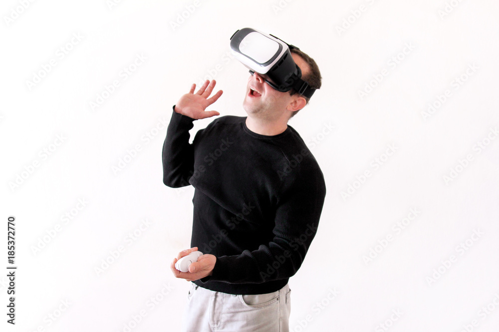 Handsome man wearing and playing virtual reality glasses on white background. Boy action in virtual reality helmet. Virtual reality headset. Young business man at office and using virtual reality box. Handsome man wearing and playing virtual reality glasses on white background. Boy action in virtual reality helmet. Virtual reality headset. Young business man at office and using virtual reality box.