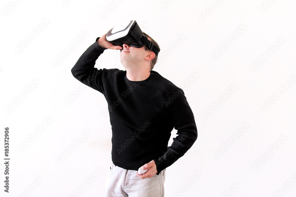 Handsome man wearing and playing virtual reality glasses on white background. Boy action in virtual reality helmet. Virtual reality headset. Young business man at office and using virtual reality box. Handsome man wearing and playing virtual reality glasses on white background. Boy action in virtual reality helmet. Virtual reality headset. Young business man at office and using virtual reality box.
