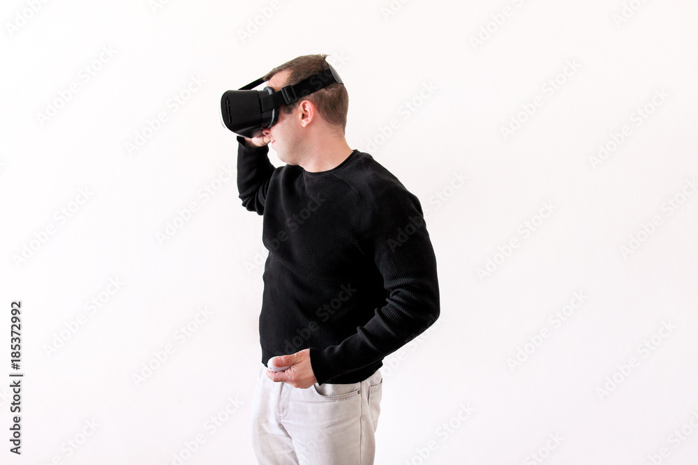 Handsome man wearing and playing virtual reality glasses on white background. Boy action in virtual reality helmet. Virtual reality headset. Young business man at office and using virtual reality box. Handsome man wearing and playing virtual reality glasses on white background. Boy action in virtual reality helmet. Virtual reality headset. Young business man at office and using virtual reality box.