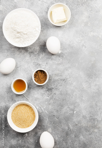 Ingredients for baking of cookies - flour, eggs, spices, vanilla, butter, sugar. Top view, copy space. Food background