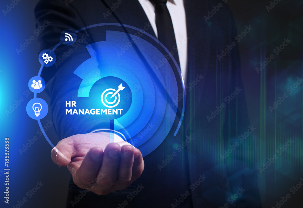 Business, Technology, Internet and network concept. Young businessman working on a virtual screen of the future and sees the inscription: HR management Business, Technology, Internet and network concept. Young businessman working on a virtual screen of the future and sees the inscription: HR management