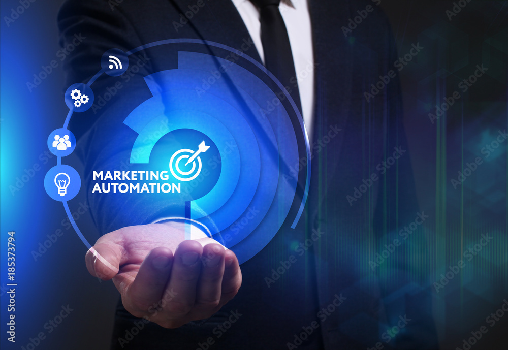 Business, Technology, Internet and network concept. Young businessman working on a virtual screen of the future and sees the inscription: Marketing automation Business, Technology, Internet and network concept. Young businessman working on a virtual screen of the future and sees the inscription: Marketing automation