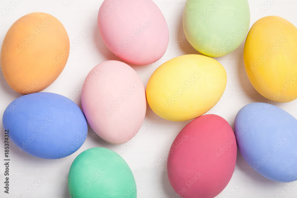 Easter composition with colored eggs on wooden white background. Easter composition with colored eggs on wooden white background.