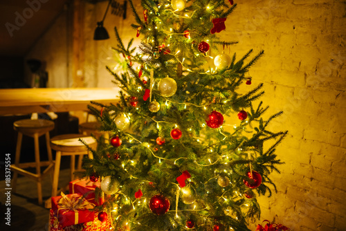 Colorful presents and the christmas tree. Christmas background. Similar focus