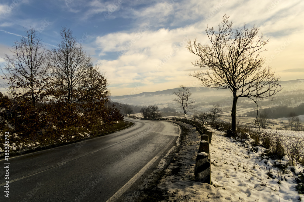 foggy winter day over road through hills foggy winter day over road through hills