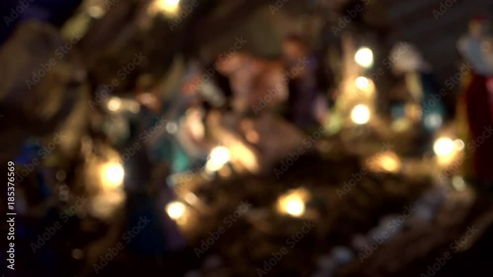 from blur to focus shot of Nativity scene with The Holy Child, The Blessed Virgin Mary, Saint Joseph, The Three Wise Men and ox and donkey from blur to focus shot of Nativity scene with The Holy Child, The Blessed Virgin Mary, Saint Joseph, The Three Wise Men and ox and donkey