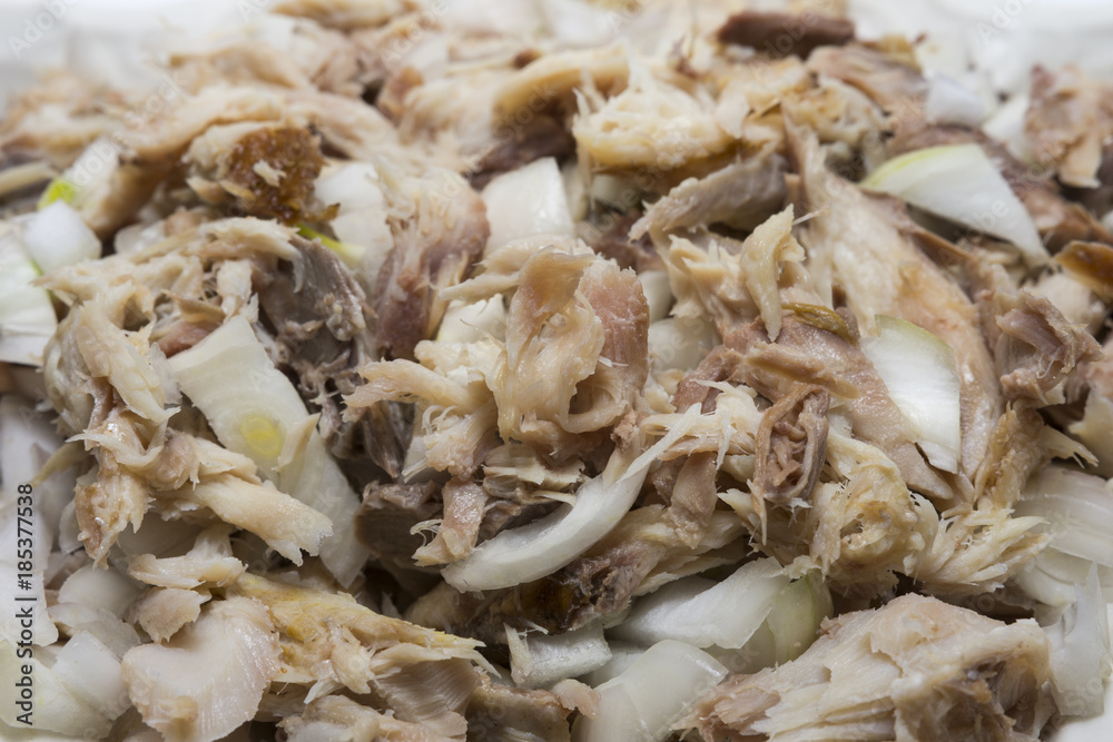 Smoked fish with onion and olive oil. Delicious dish. Fabulous taste. Selective focus. Smoked fish with onion and olive oil. Delicious dish. Fabulous taste. Selective focus.