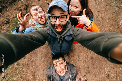 Four crazy funny people selfie. Bizarre scary company mess outdoor. Disgusting creepy fellows fooling around. Unusual dirty face emotions. Wide angle distortions. Evil family. Expressive pesrons party © benevolente