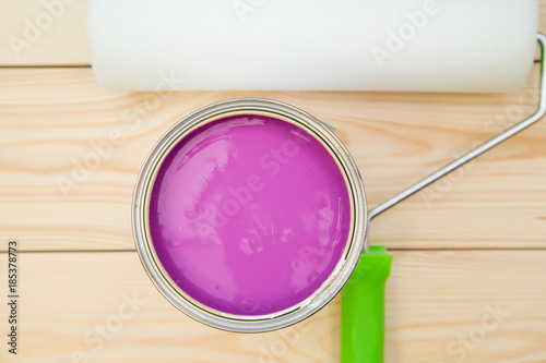 A can of blue paint and a paint roller photo