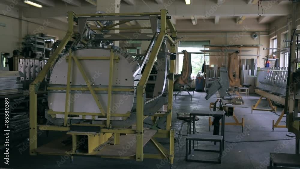 Panoramic shot of the parts of aircraft fuselage in the assembly shop. Inside aircraft workshop. Aviation industry development. Panoramic shot of the parts of aircraft fuselage in the assembly shop. Inside aircraft workshop. Aviation industry development.