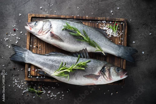 Panel kuchenny z motywem Fresh fish seabass on black background.