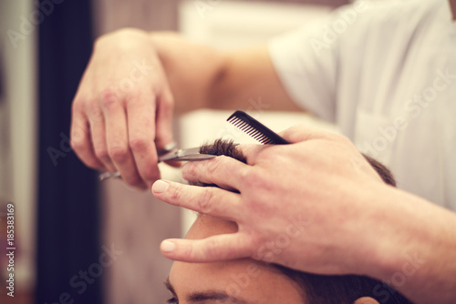 Barber at work. Hairdresser cutting hair of client © zeljkomatic76