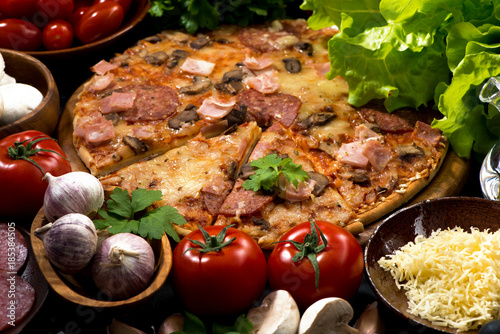 pizza with sausage and cheese and variety of ingredients, horizontal