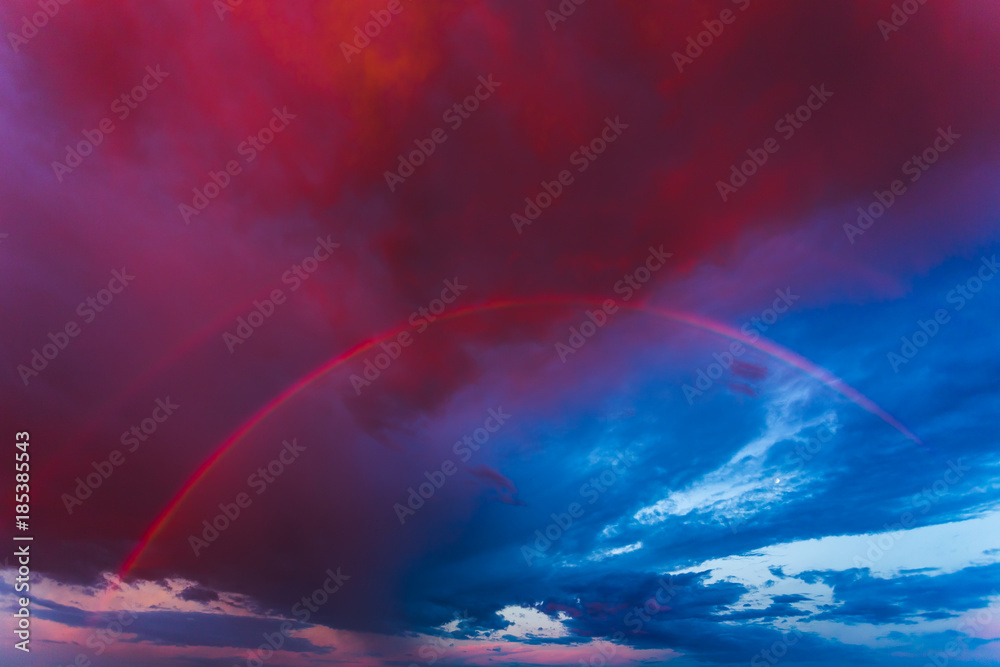 Double rainbow in the purple evening sky