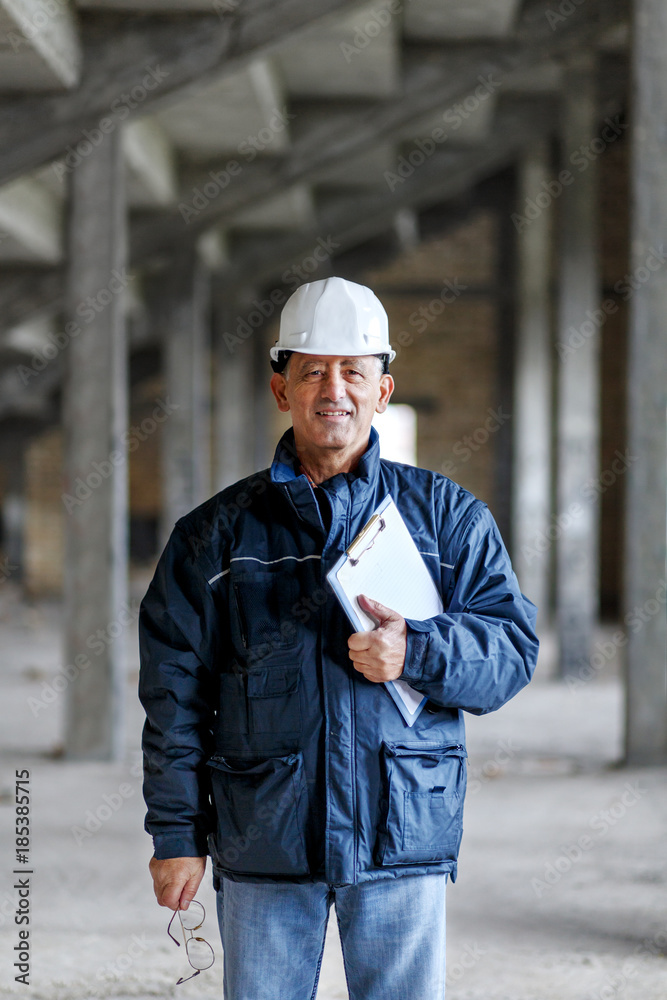 Senior construction manager controlling building site.