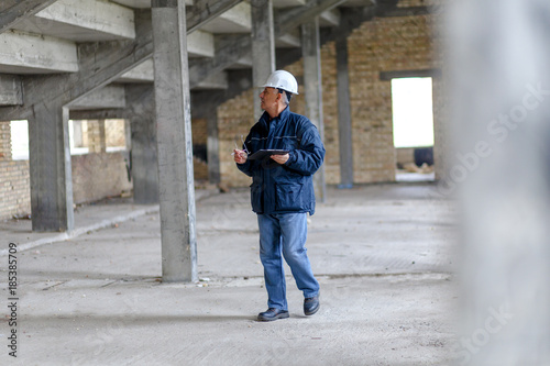 Senior construction manager controlling building site. © Zoran Zeremski