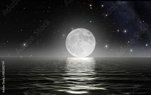 Moon rising over the ocean with starry sky in the background