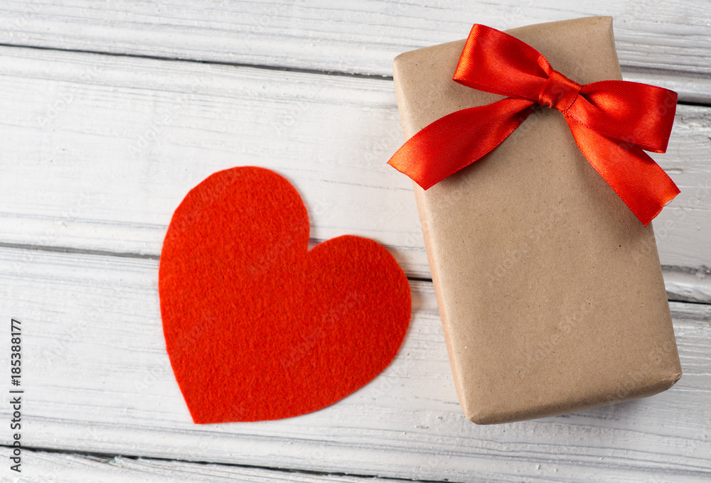 red heart and gift on wooden background red heart and gift on wooden background