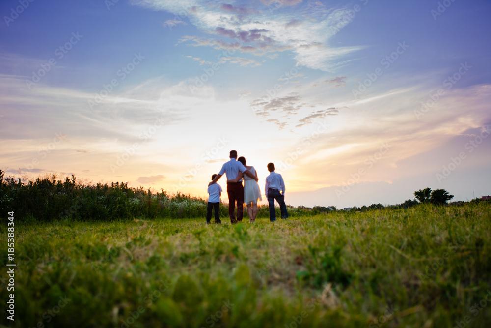 Happy family on the background of the sunset Happy family on the background of the sunset